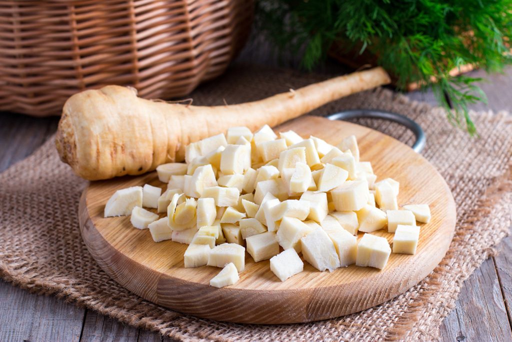 Fresh sliced parsnips on a wooden board