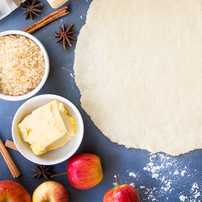 Making apple pie for autumn baking concept,pie dough in center with dessert ingredients