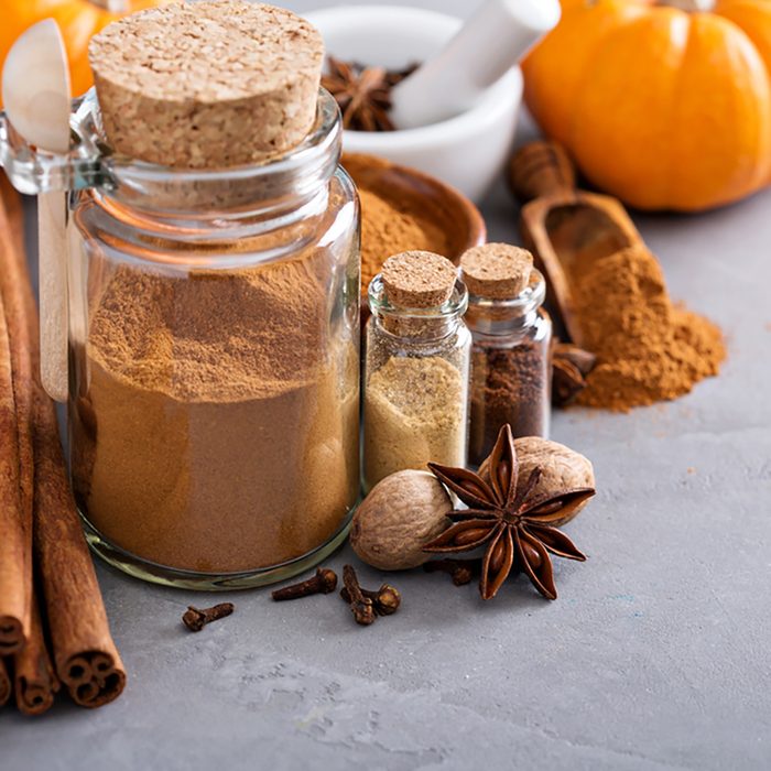 Homemade pumpkin pie spice in a glass jar with ingredients