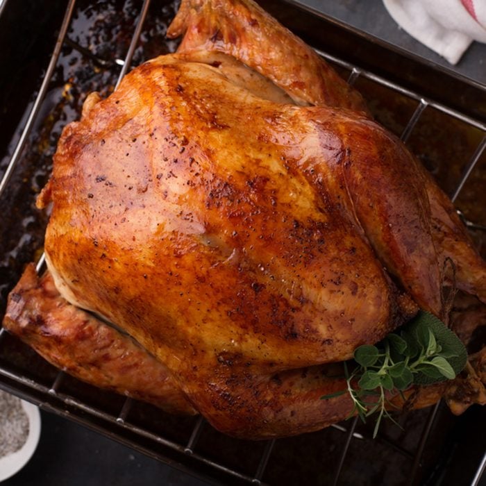 Cooked turkey for Thanksgiving or Christmas in a roasting pan ready for carving