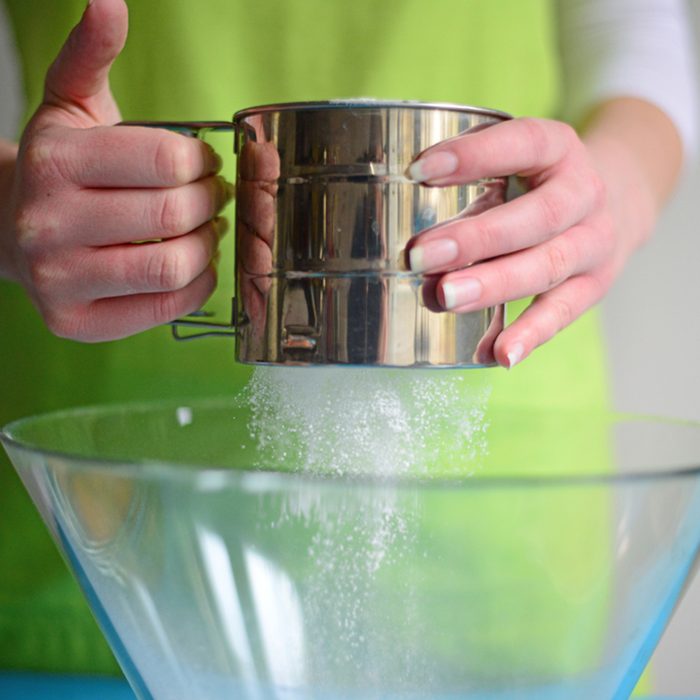 Flour sifting through a sieve for a baking