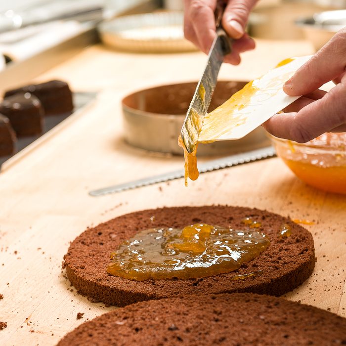 Cook making layer chocolate cake with orange marmalade; Shutterstock ID 134874809; Job (TFH, TOH, RD, BNB, CWM, CM): Taste of Home