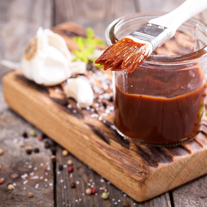 Barbeque sauce with a basting brush in a jar