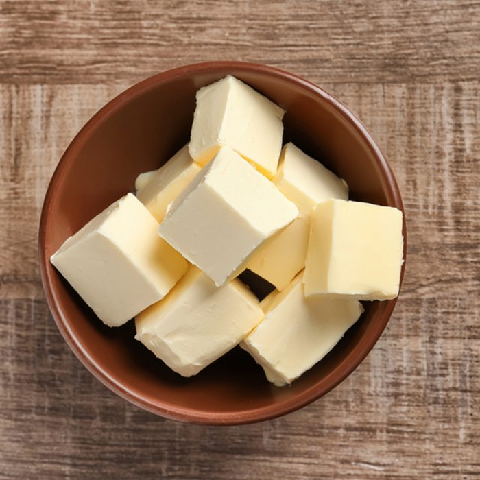 Bowl with cubes of butter on wooden background; Shutterstock ID 751443889; Job (TFH, TOH, RD, BNB, CWM, CM): Taste of Home