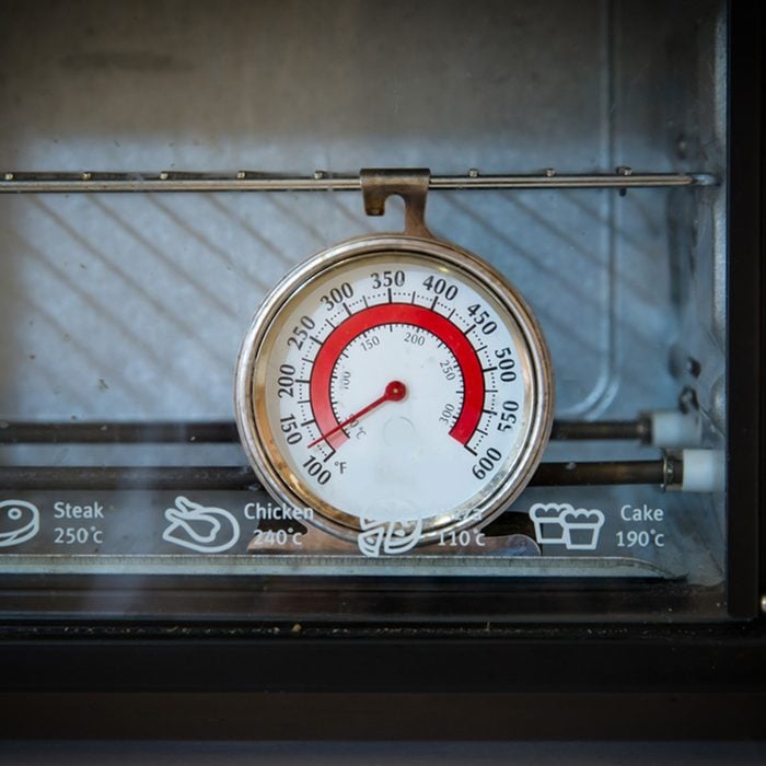 Old oven thermometer in the kitchen at home