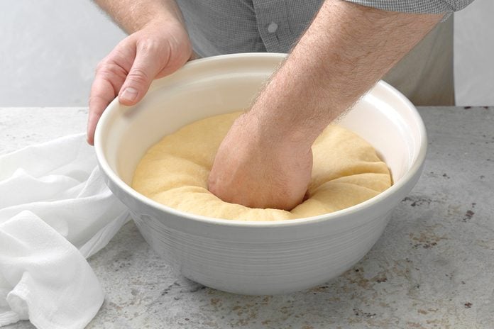 Punching Down Dough, Towel From The Rising Process On Table