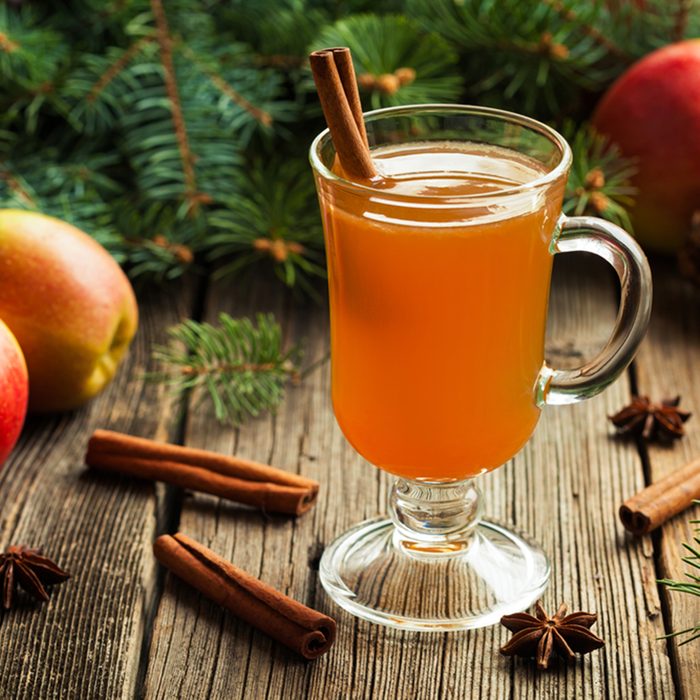 Hot apple cider traditional winter season drink with cinnamon and anise. Homemade healthy organic warm spice beverage. Christmas or thanksgiving holiday decoration on vintage wooden background.; Shutterstock ID 337633124; Job (TFH, TOH, RD, BNB, CWM, CM): TOH