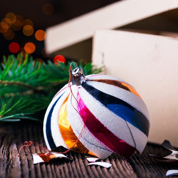 Broken old vintage Christmas balls on wooden table.