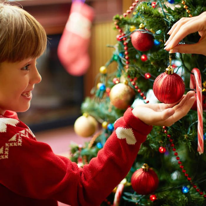 Child being presented an ornament