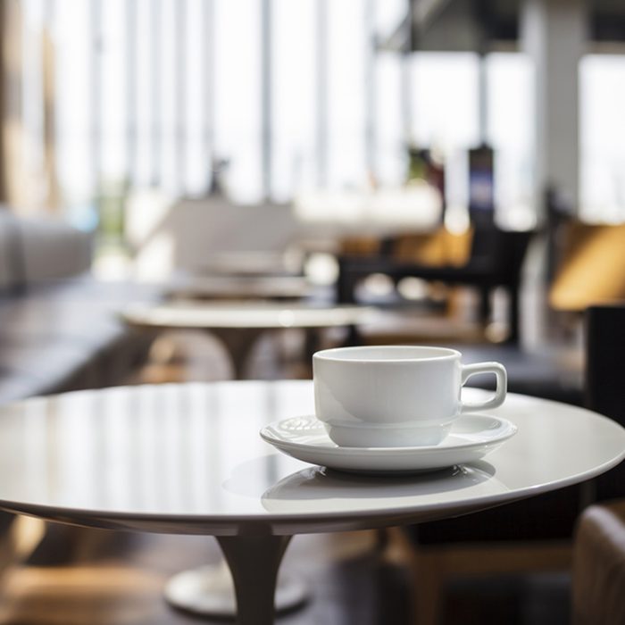 Coffee Cup on table Cafe shop Interior Blur people background