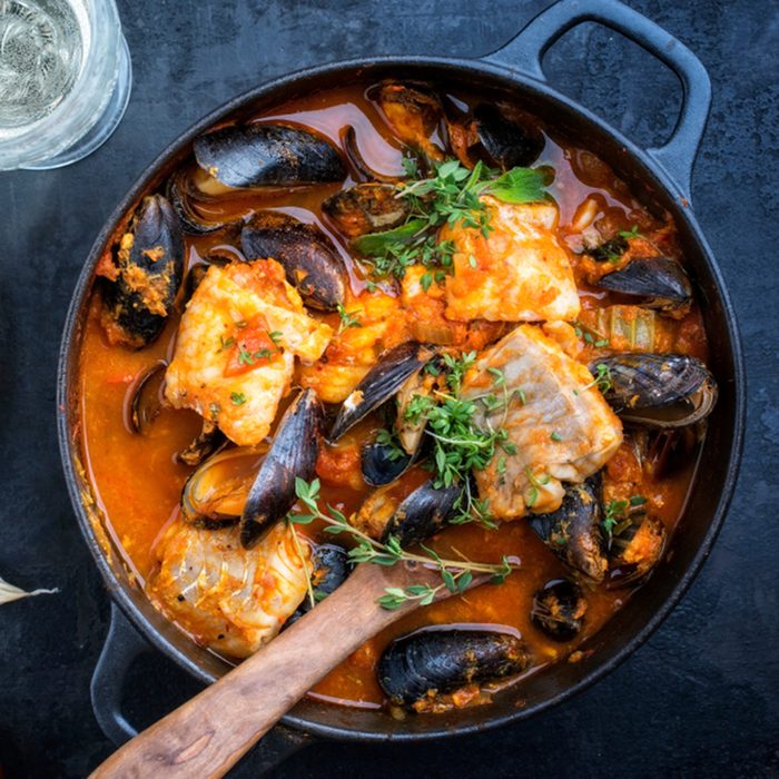 Traditional French Corsican fish stew with mussels and garlic baguette as top view in a pot; Shutterstock ID 1060620911; Job (TFH, TOH, RD, BNB, CWM, CM): TOH