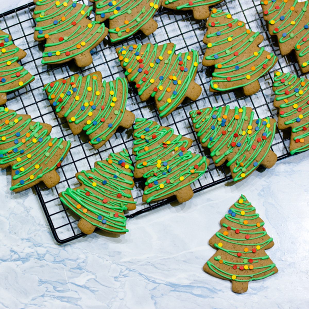 gingerbread cookies with green icing and colorful sugar sprinkles shaped Christmas tree for kids winter holiday treat