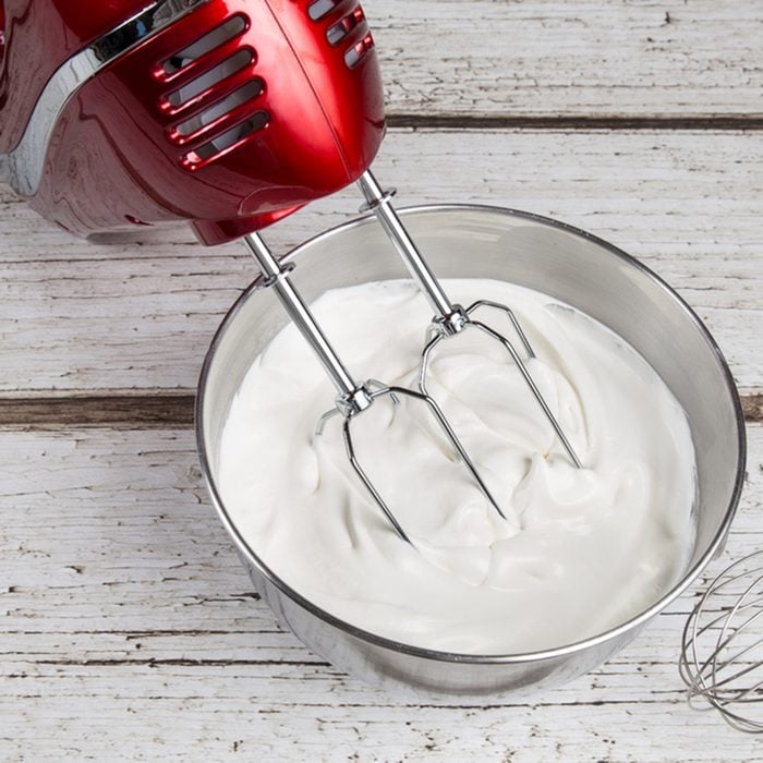Electric hand mixer with whipped cream and whisk
