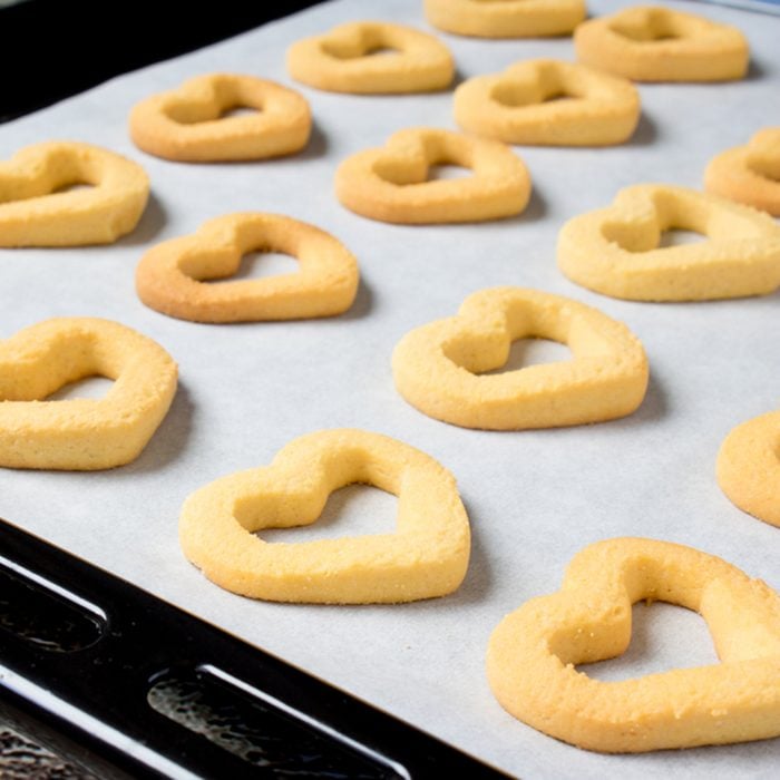Butter cookies heart-shaped on a cookie sheet, fresh from the oven; Shutterstock ID 591182369; Job (TFH, TOH, RD, BNB, CWM, CM): Taste of Home