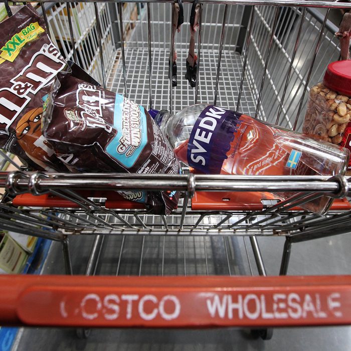 Candy, nuts and liquor sit in a customer's cart at a Costco warehouse store, in Seattle.