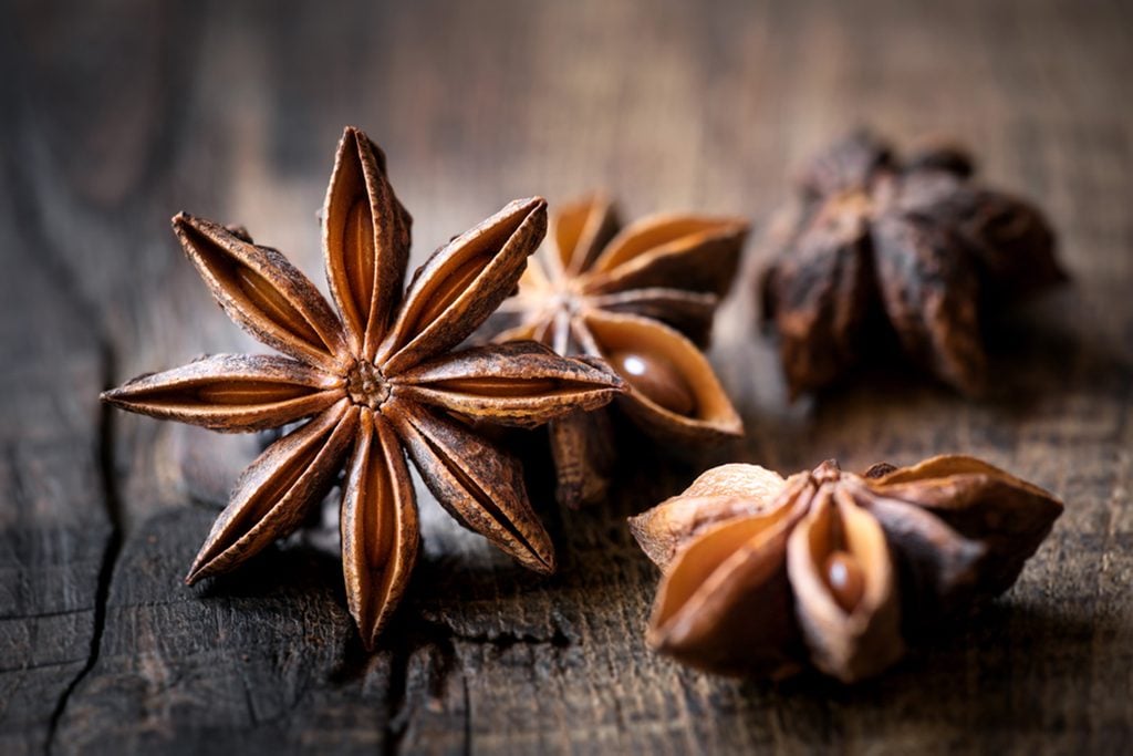 Star anise closeup against dark rustic wooden background