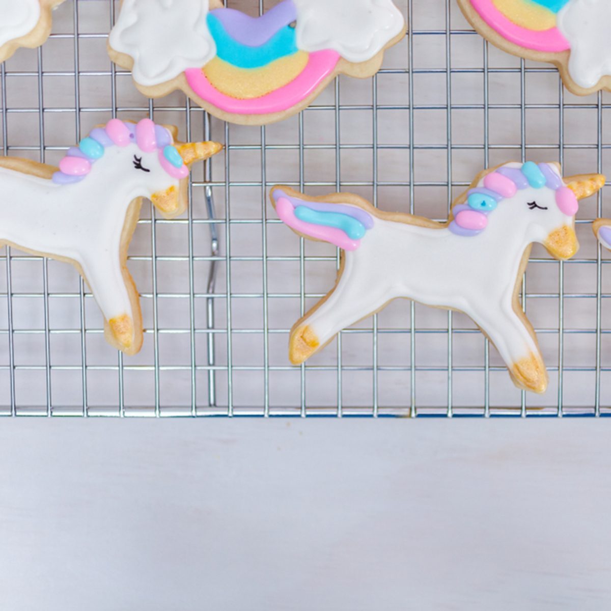 Decorating unicorn themed sugar cookies with royal icing.