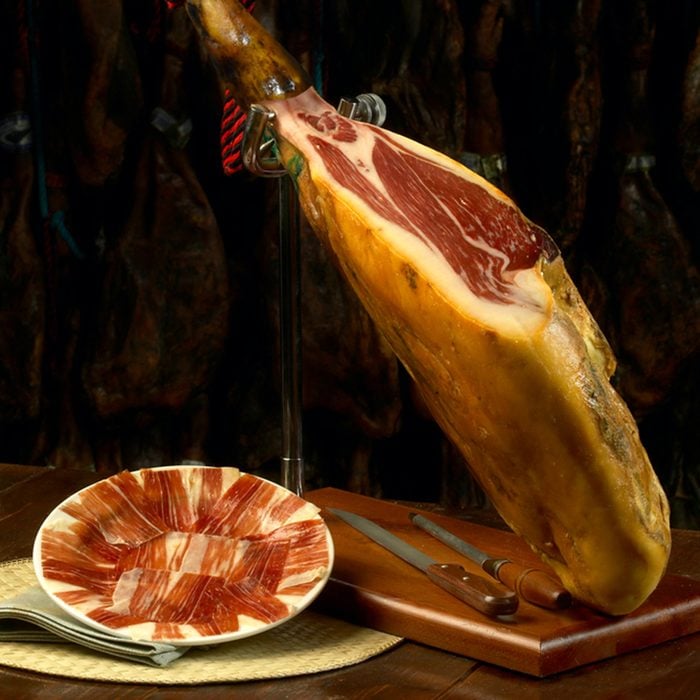 Iberian ham with a plate of slices of ham.