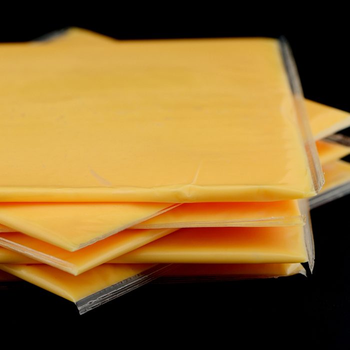 Several slices of american cheese in the studio
