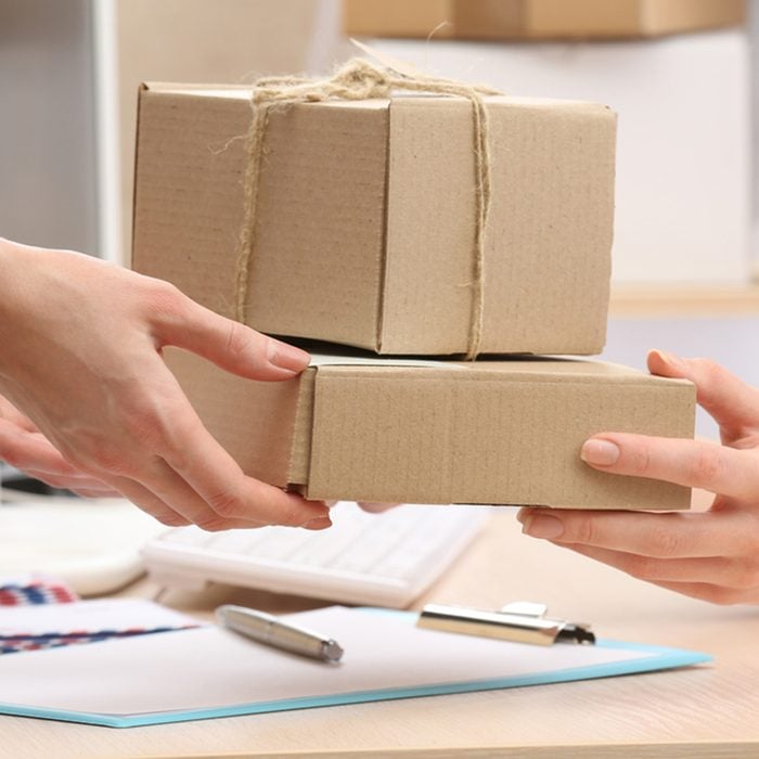 Woman gives parcel in post office; Shutterstock ID 282916904; Job (TFH, TOH, RD, BNB, CWM, CM): TOH