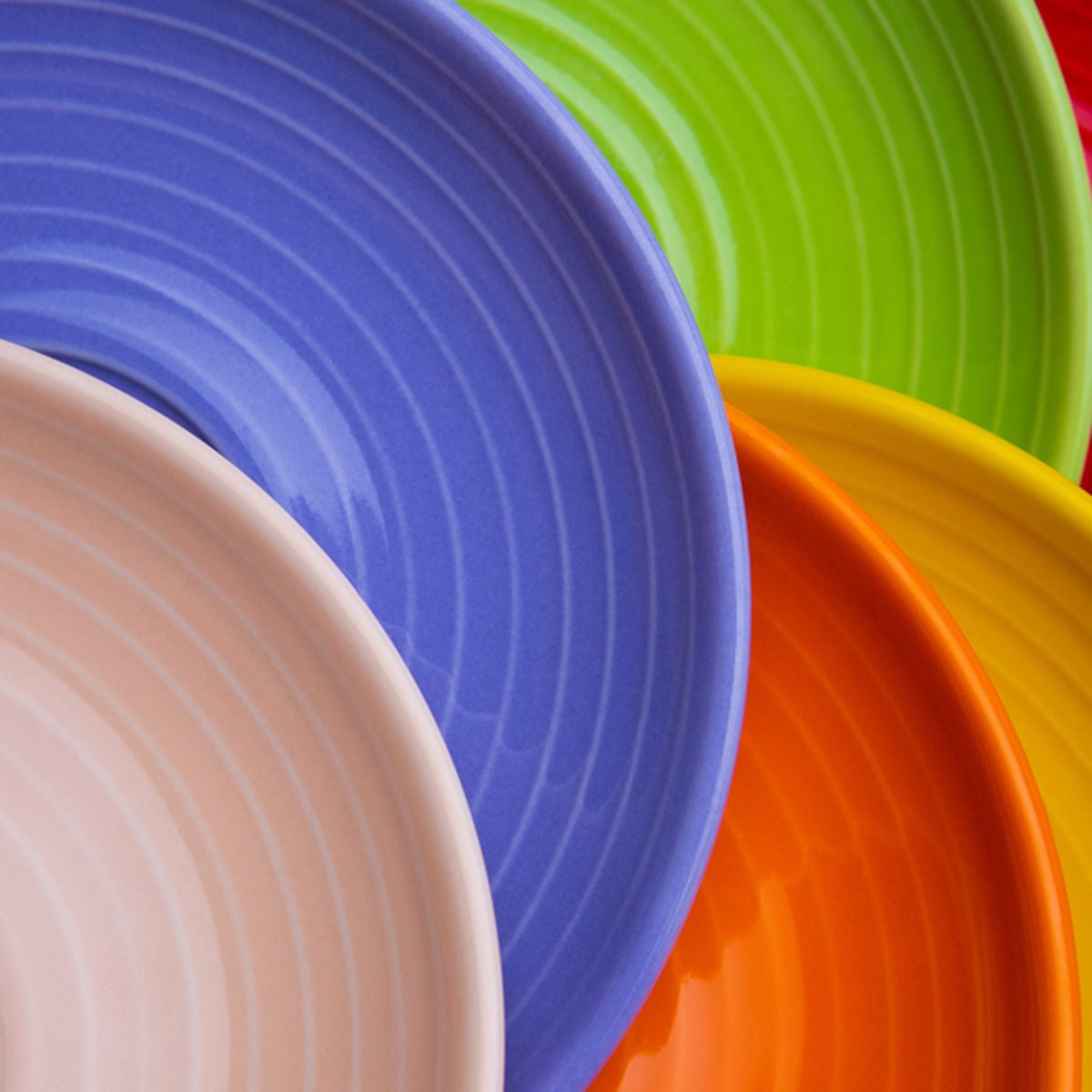 Collection of colorful red, green, blue, orange, biege dishes on white background