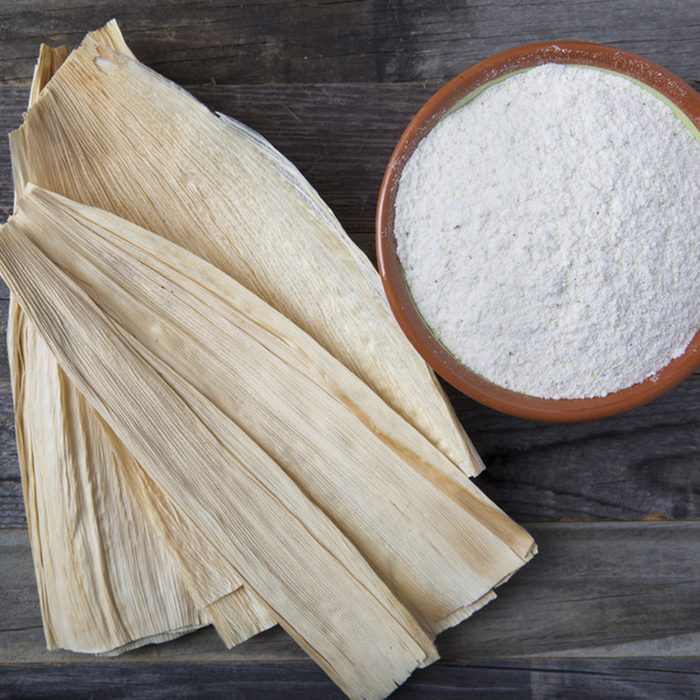 Corn masa flour and corn husks for preparing tamales.