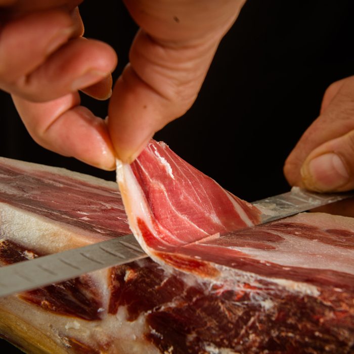 Cutting a slice of iberian ham