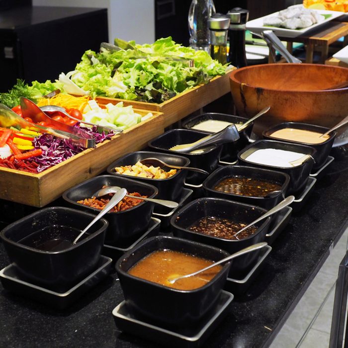 Colorful fresh vegetables prepared for chosen in salad bar buffet line with various kind of salad dressing.