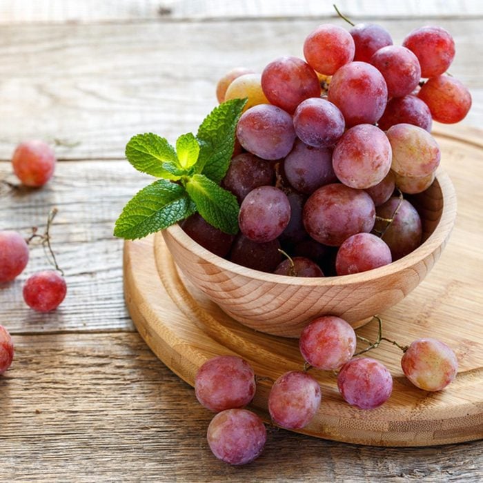 Bowl with pink grapes on a wooden stand.; Shutterstock ID 523852714; Job (TFH, TOH, RD, BNB, CWM, CM): TOH