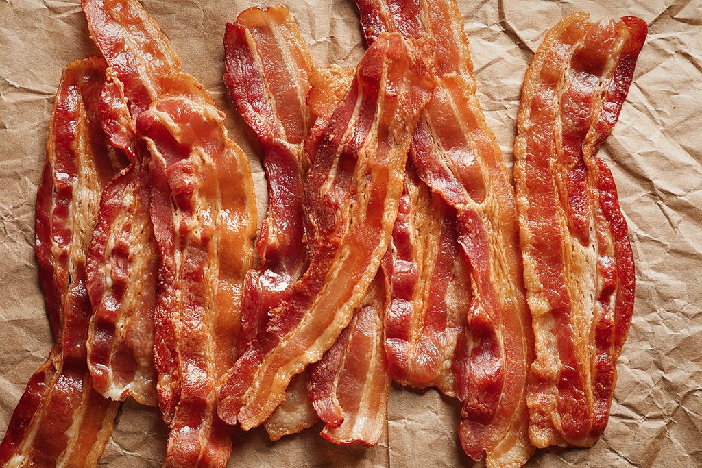 Cooked bacon rashers on parchment; Shutterstock ID 758704648