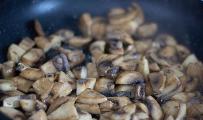 Photo of mushrooms browning in pan