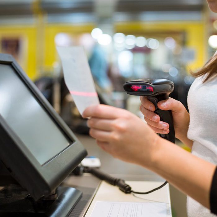 Cashier using a scanner
