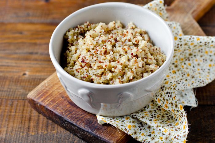 Boiled quinoa in a bowl on a wooden table