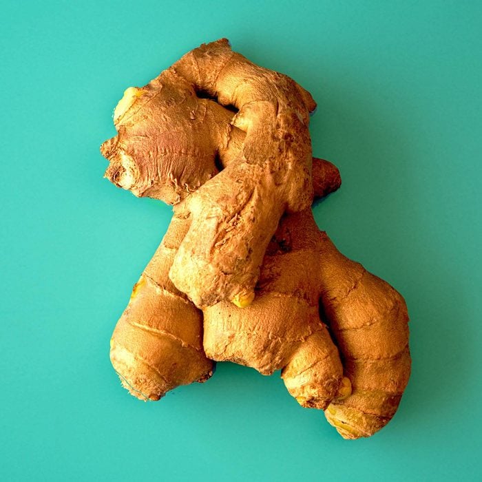 Raw ginger root in blue background.