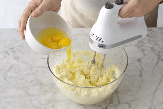 Lemon Bundt cake mixing eggs in with mixer