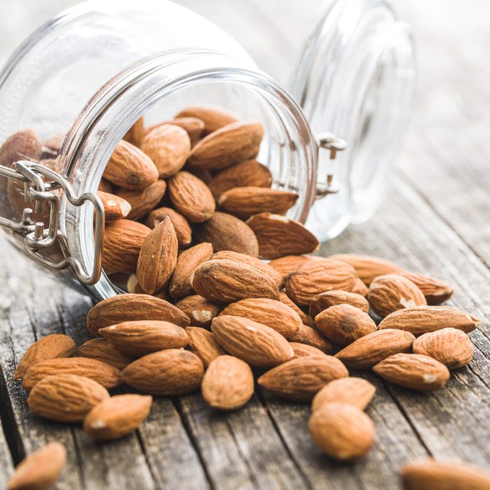 Dried almond nuts in jar.