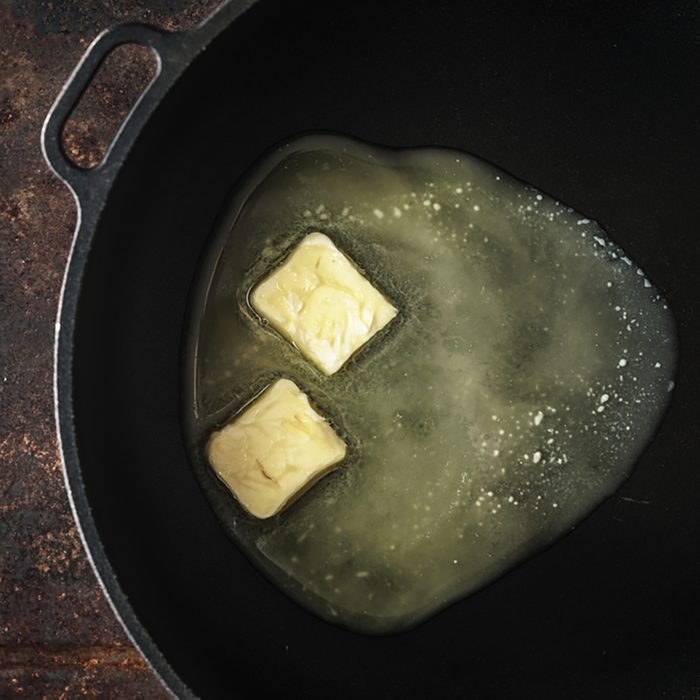 Pieces of butter in the hot pan top view