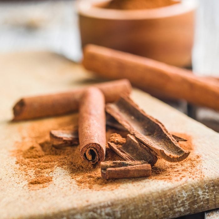 Cinnamon sticks and milled cinnamon spice on old table.