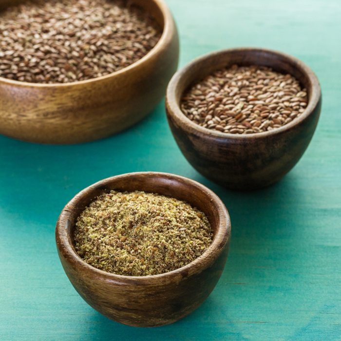 Flax seeds on painted wood board.