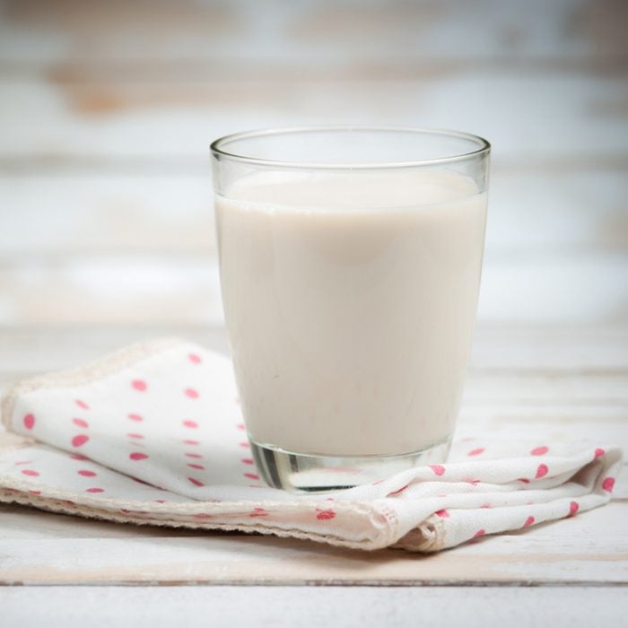 Glass of milk on wooden background