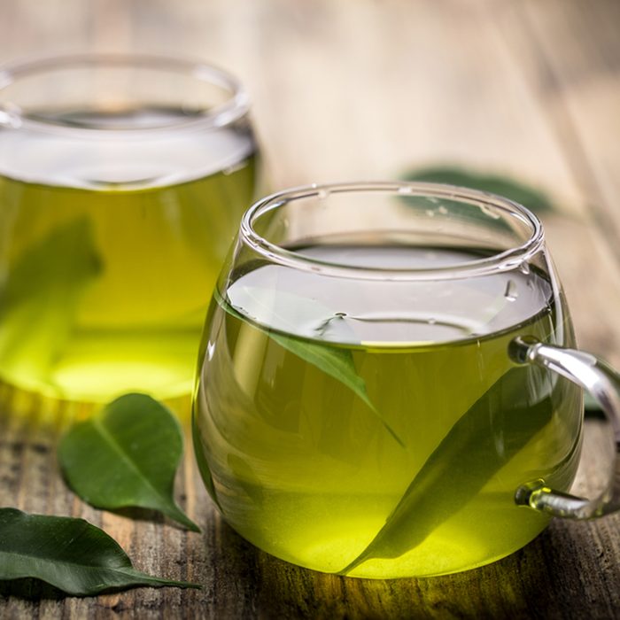 Fresh green tea with tea leaves in the water