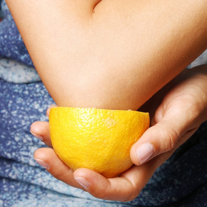 Young woman making an elbow cosmetic treatment