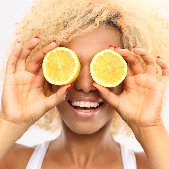 Dark skinned girl with fruits lemon