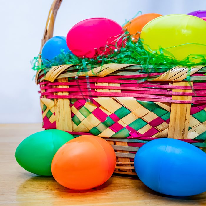 Easter basket with colorful plastic Easter eggs