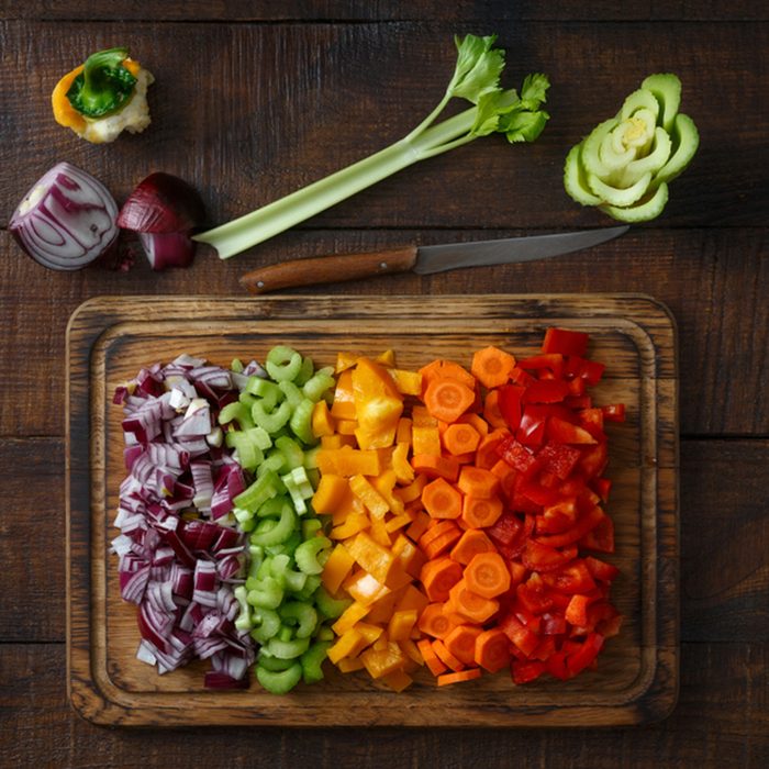 Chopped vegetables arranged on cutting board on wooden table