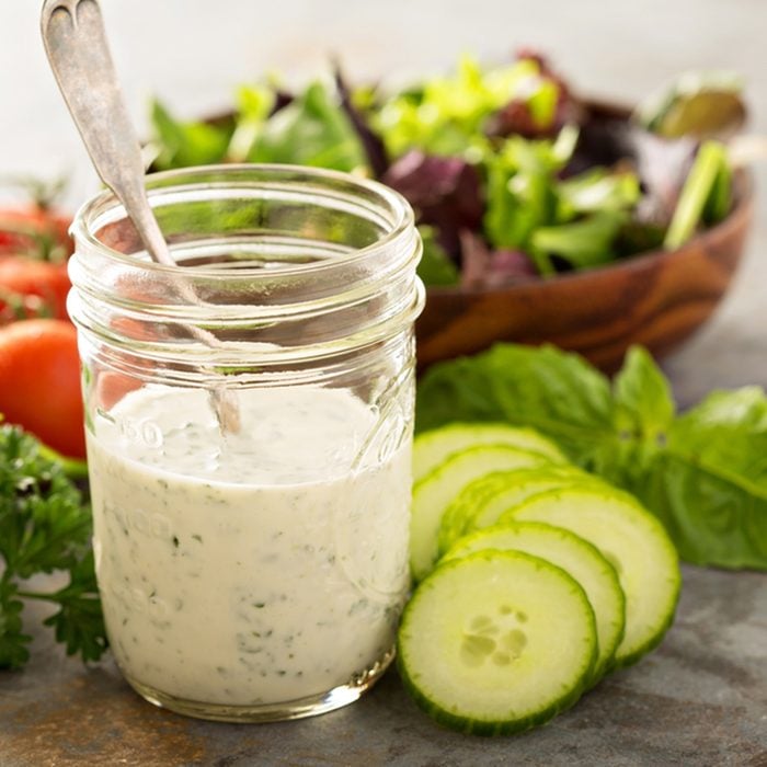 Homemade ranch dressing in a mason jar with fresh vegetables