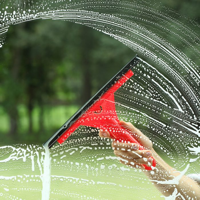 Windows cleaning, glass without smudges red squeegee; Shutterstock ID 123204070; Job (TFH, TOH, RD, BNB, CWM, CM): TOH
