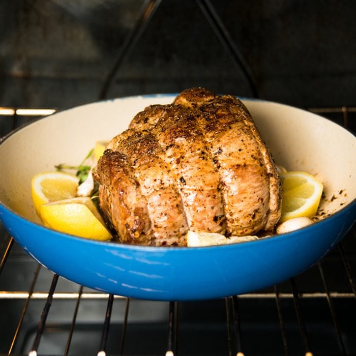 Pork Shoulder Roasting in Oven with Herbs and Lemons; Shutterstock ID 123768226; Job (TFH, TOH, RD, BNB, CWM, CM): TOH