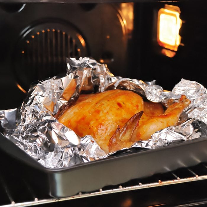 Cooking juicy golden chicken in oven and foil; Shutterstock ID 241082368; Job (TFH, TOH, RD, BNB, CWM, CM): TOH