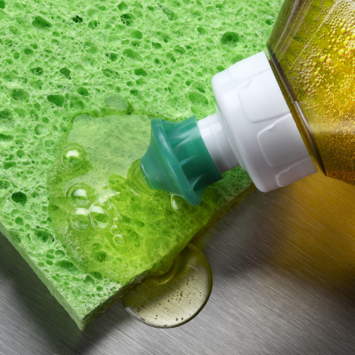macro shot of dish soap being squeezed onto green sponge in aluminum sink; Shutterstock ID 57254341; Job (TFH, TOH, RD, BNB, CWM, CM): TOH